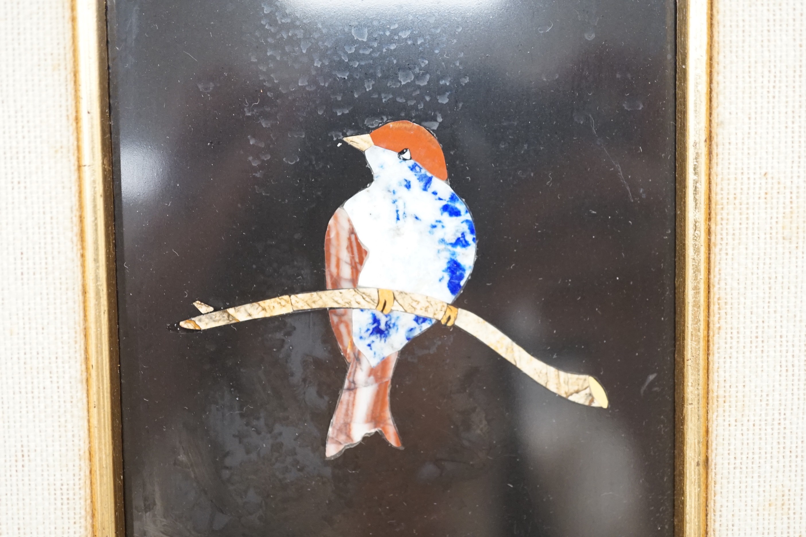 A 20th century Italian pietra dura marble plaque, depicting a bird on a branch, indistinctly signed. 14x8.5cm excl frame.